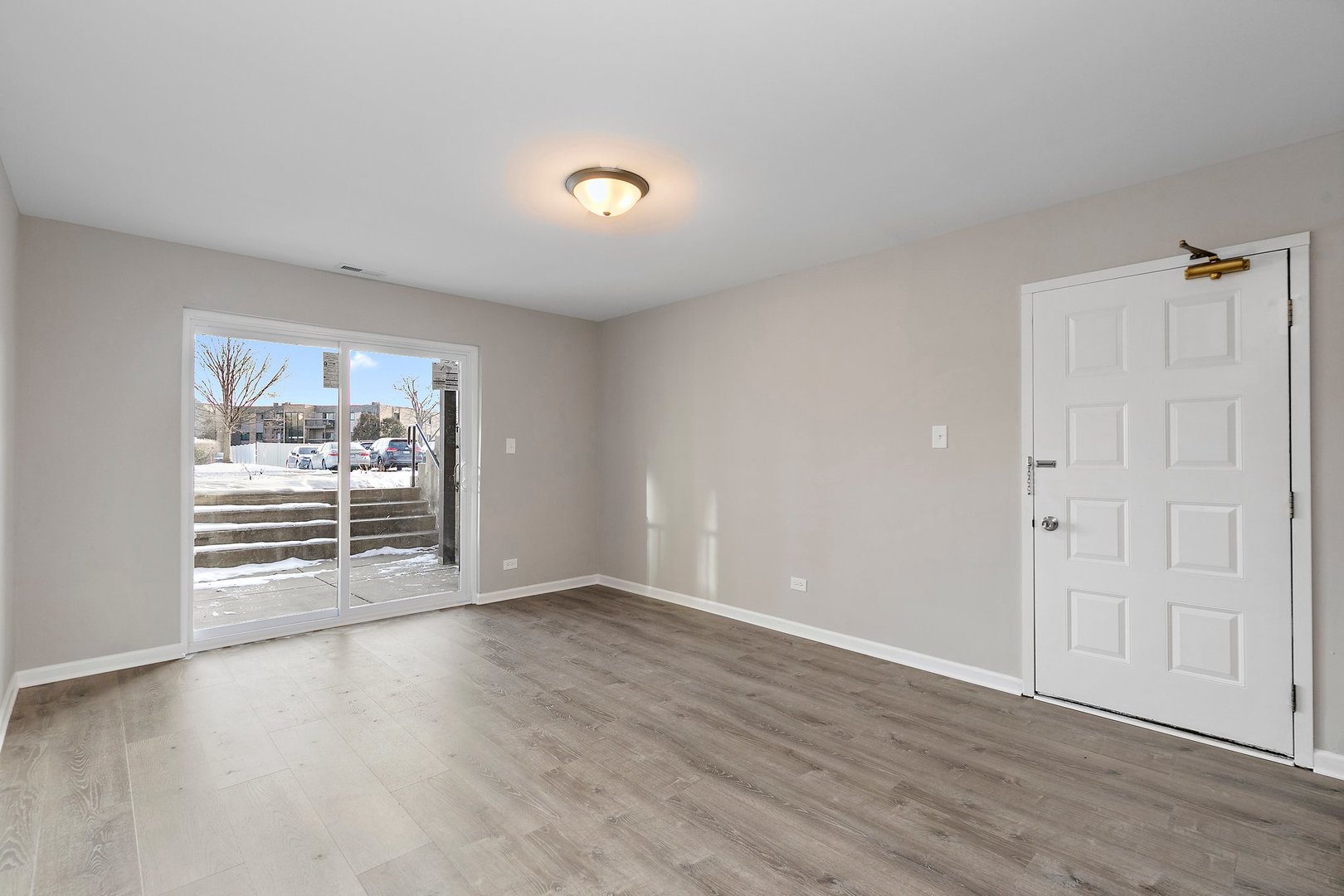 1484 Stonebridge Circle, Unit B4 Wheaton, IL 60189 - Photo 2 of 14 wooden floor in an empty room with a window