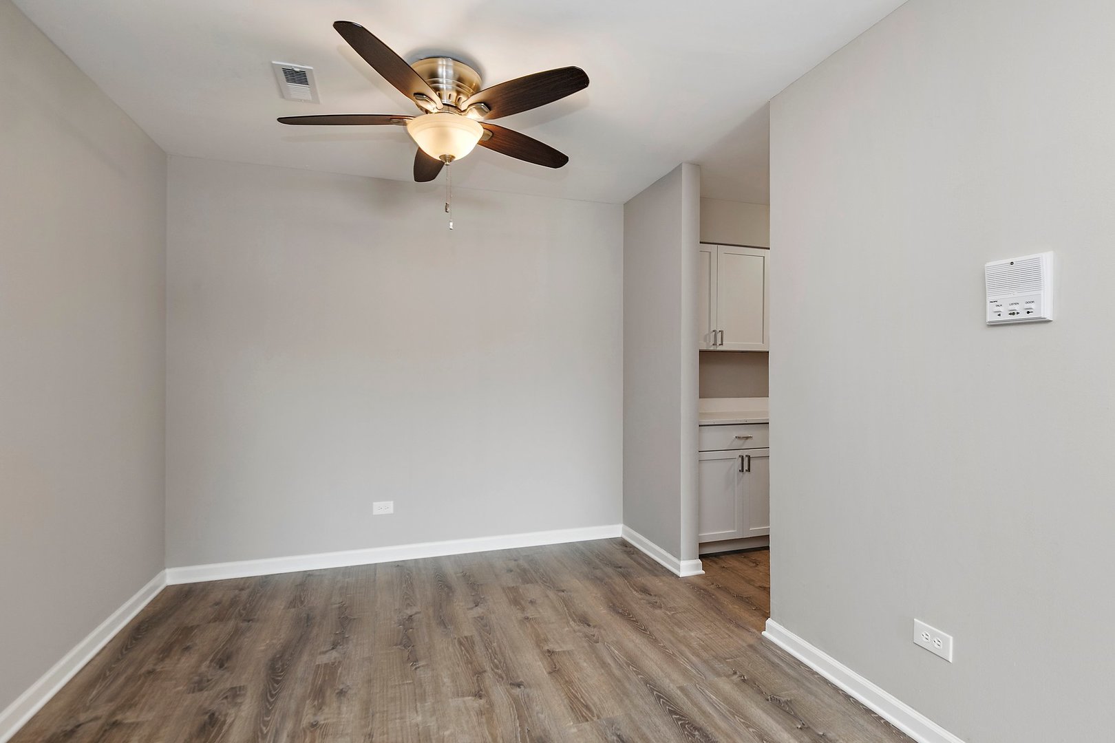1484 Stonebridge Circle, Unit B4 Wheaton, IL 60189 - Photo 5 of 14 an empty room with wooden floor and ceiling fan
