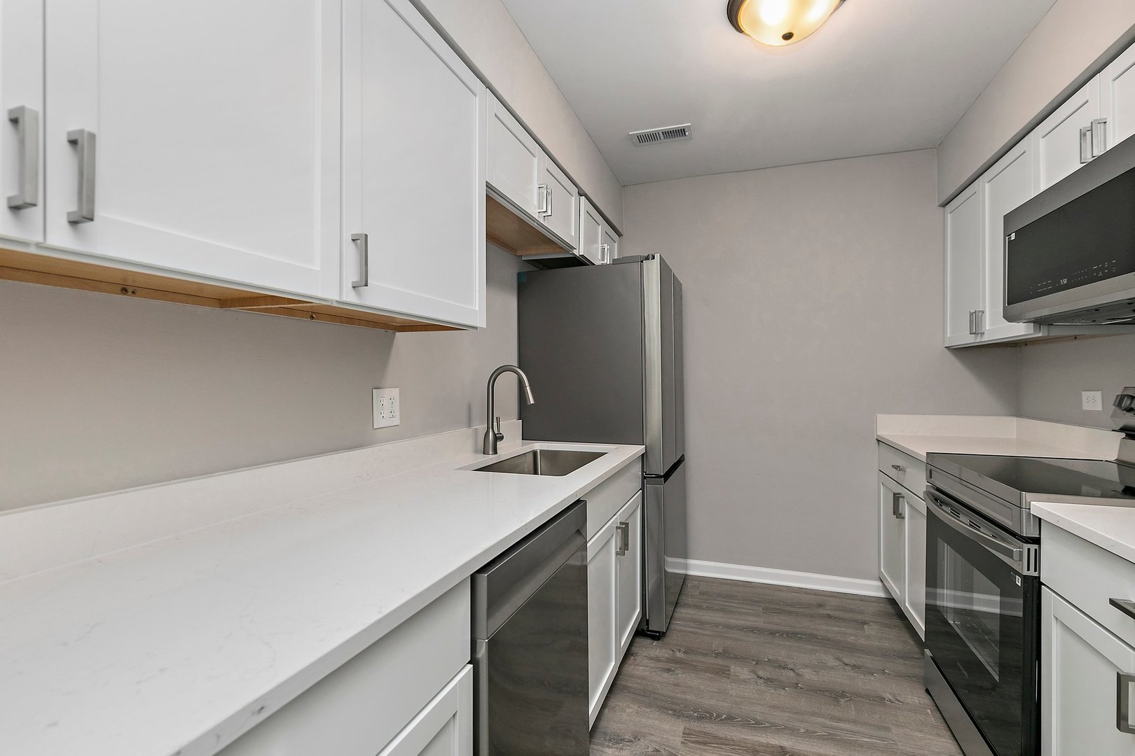 1484 Stonebridge Circle, Unit B4 Wheaton, IL 60189 - Photo 6 of 14 a kitchen with stainless steel appliances granite countertop a sink stove and refrigerator
