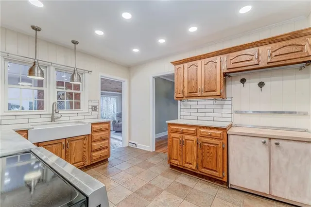 a kitchen with stainless steel appliances granite countertop a sink and cabinets