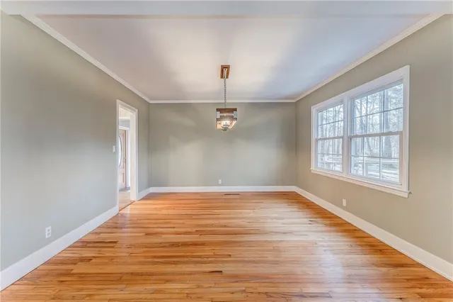 a view of a livingroom with a fireplace and wooden floor