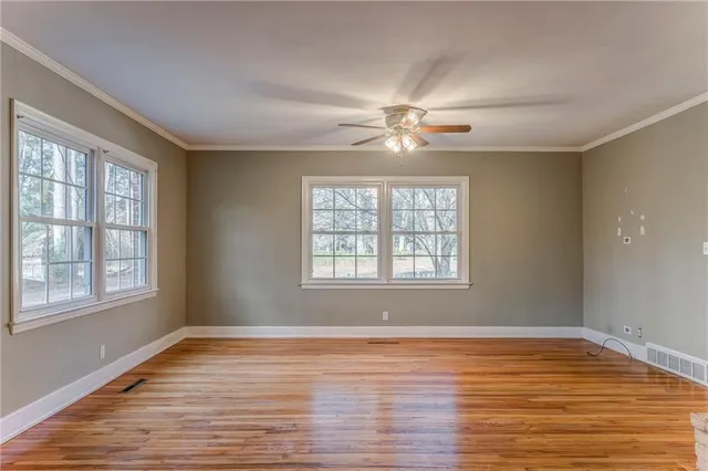 wooden floor in an empty room with a window