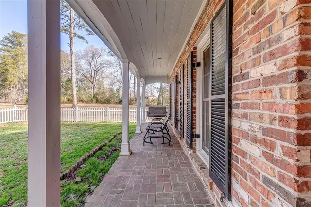 a kitchen with granite countertop a stove top oven microwave and cabinets