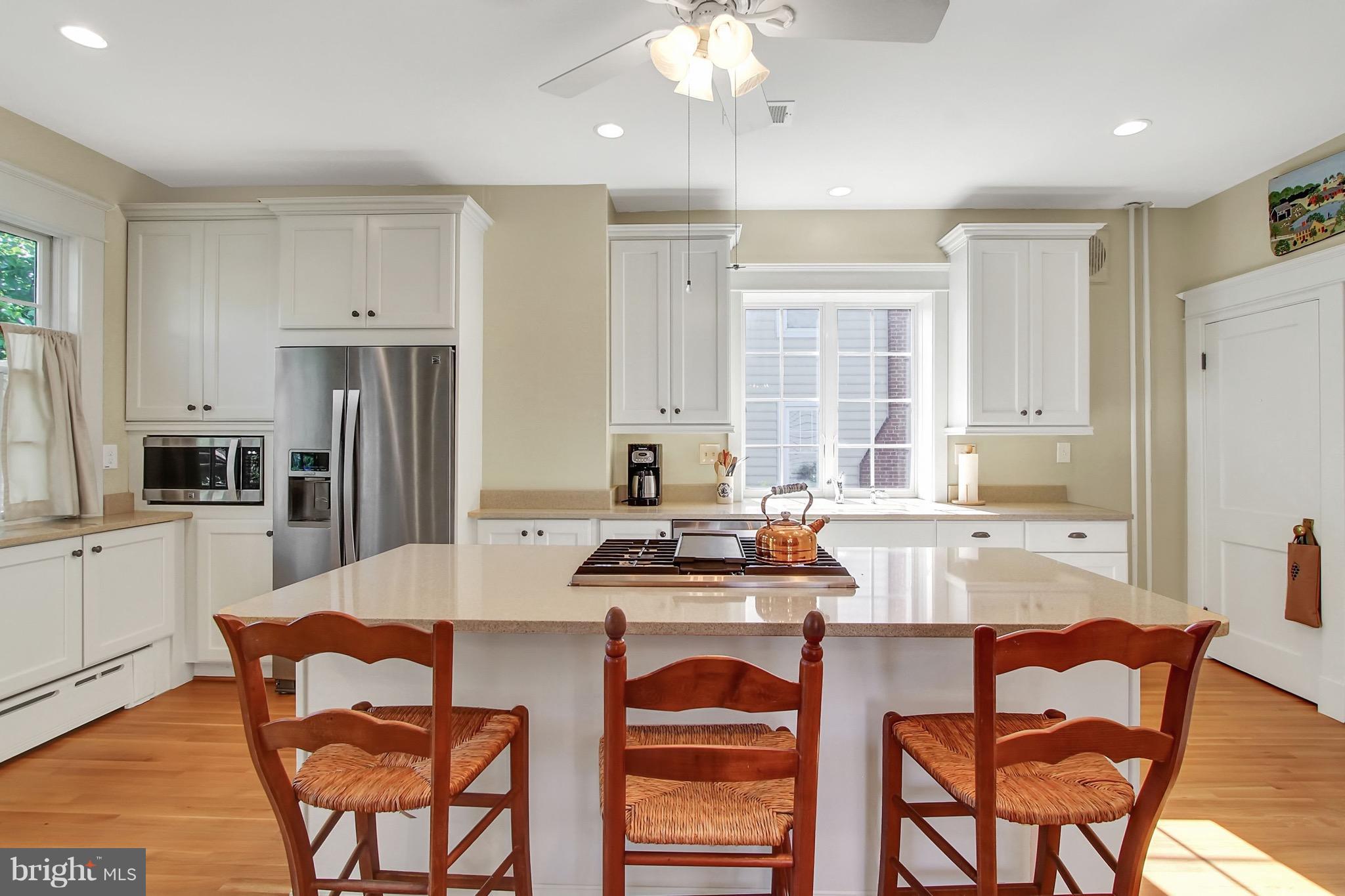 600 Murdock Road Baltimore, MD 21212 - Photo 13 of 30 a kitchen with stainless steel appliances a table chairs refrigerator and microwave