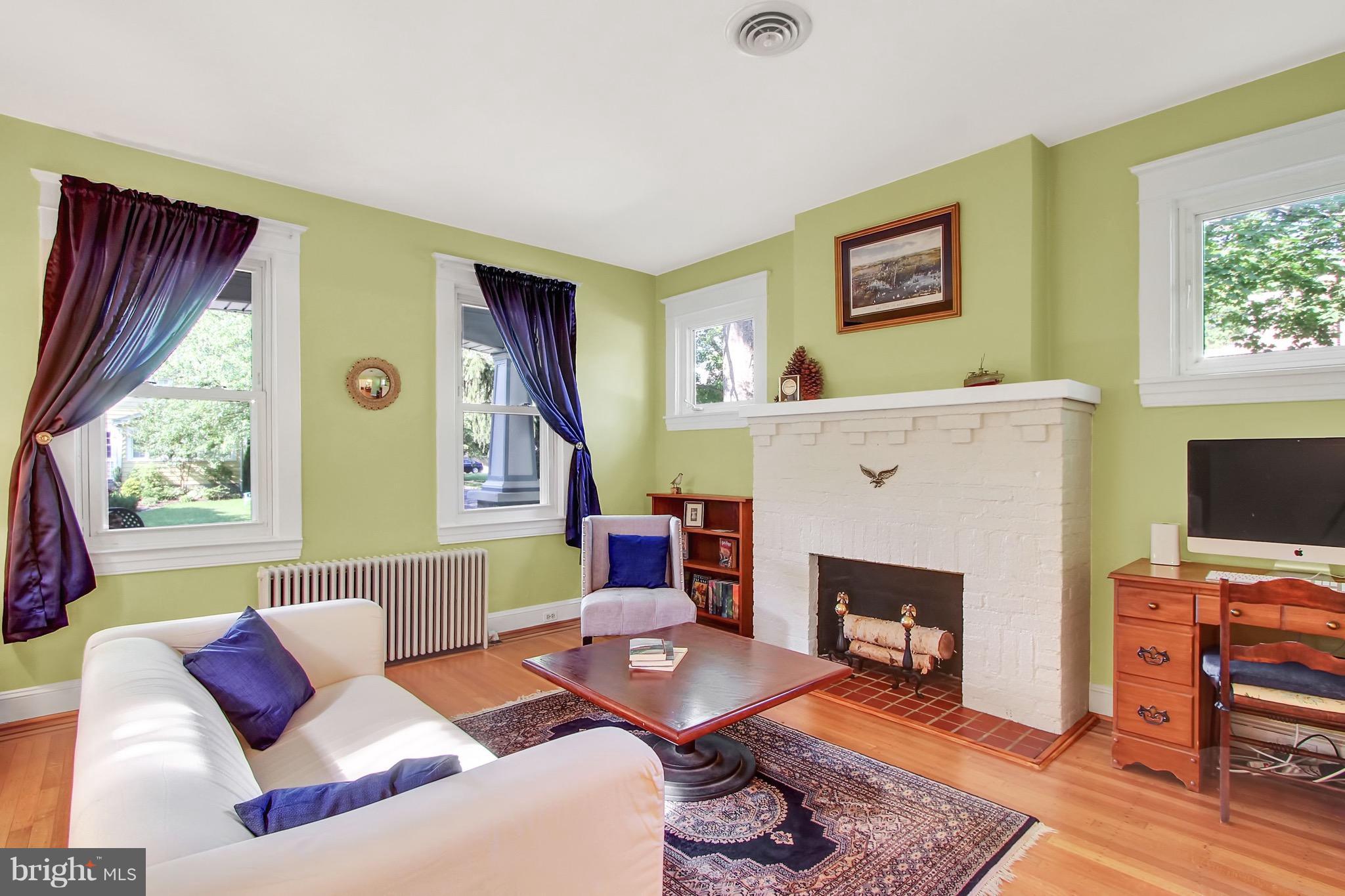 600 Murdock Road Baltimore, MD 21212 - Photo 7 of 30 a living room with furniture a flat screen tv and a fireplace