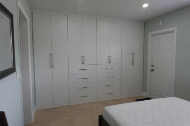 a bedroom with a bed and cabinets