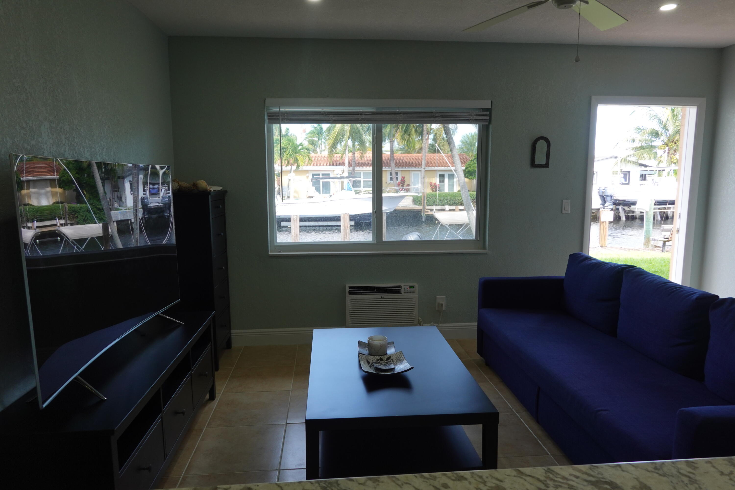 301 East McNab Road, Unit 113 Pompano Beach, FL 33060 - Photo 20 of 21 a living room with furniture and a window