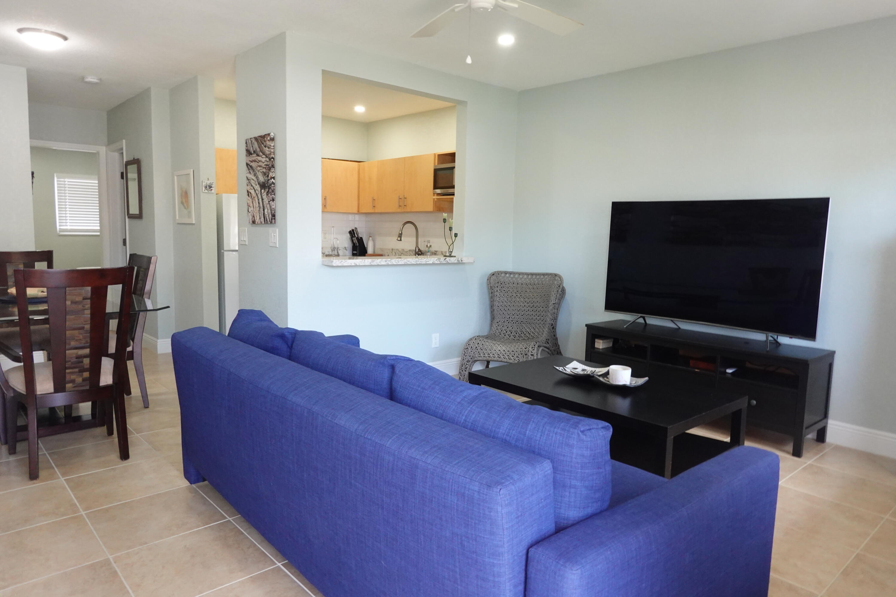 301 East McNab Road, Unit 113 Pompano Beach, FL 33060 - Photo 2 of 21 a living room with furniture and a flat screen tv