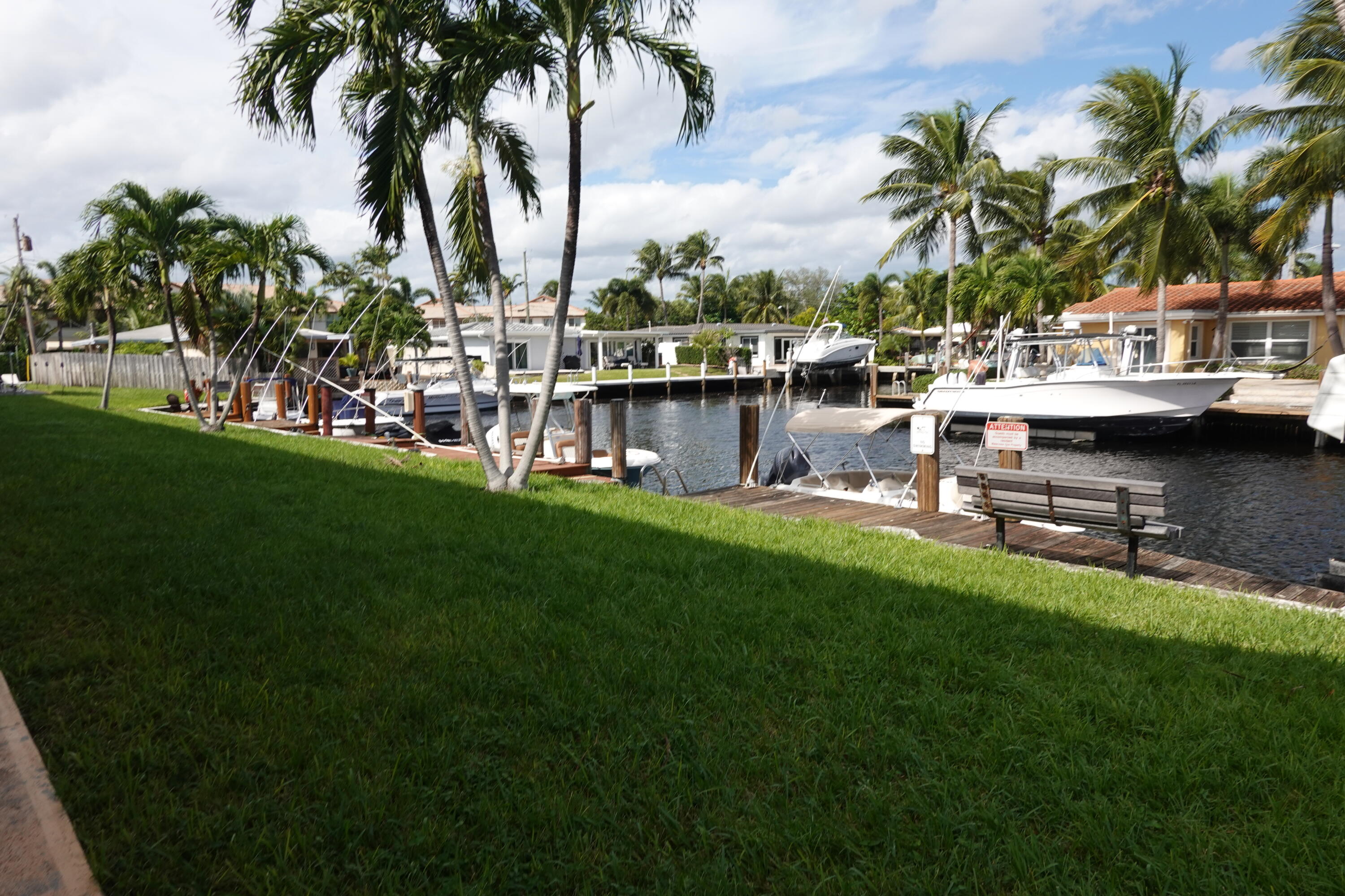 301 East McNab Road, Unit 113 Pompano Beach, FL 33060 - Photo 21 of 21 a row of palm trees sitting in a yard with swimming pool