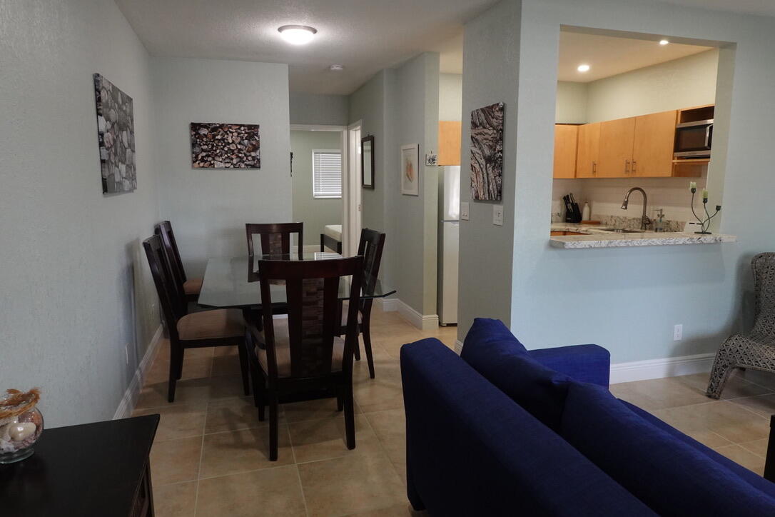 301 East McNab Road, Unit 113 Pompano Beach, FL 33060 - Photo 5 of 21 a view of a dining room with furniture