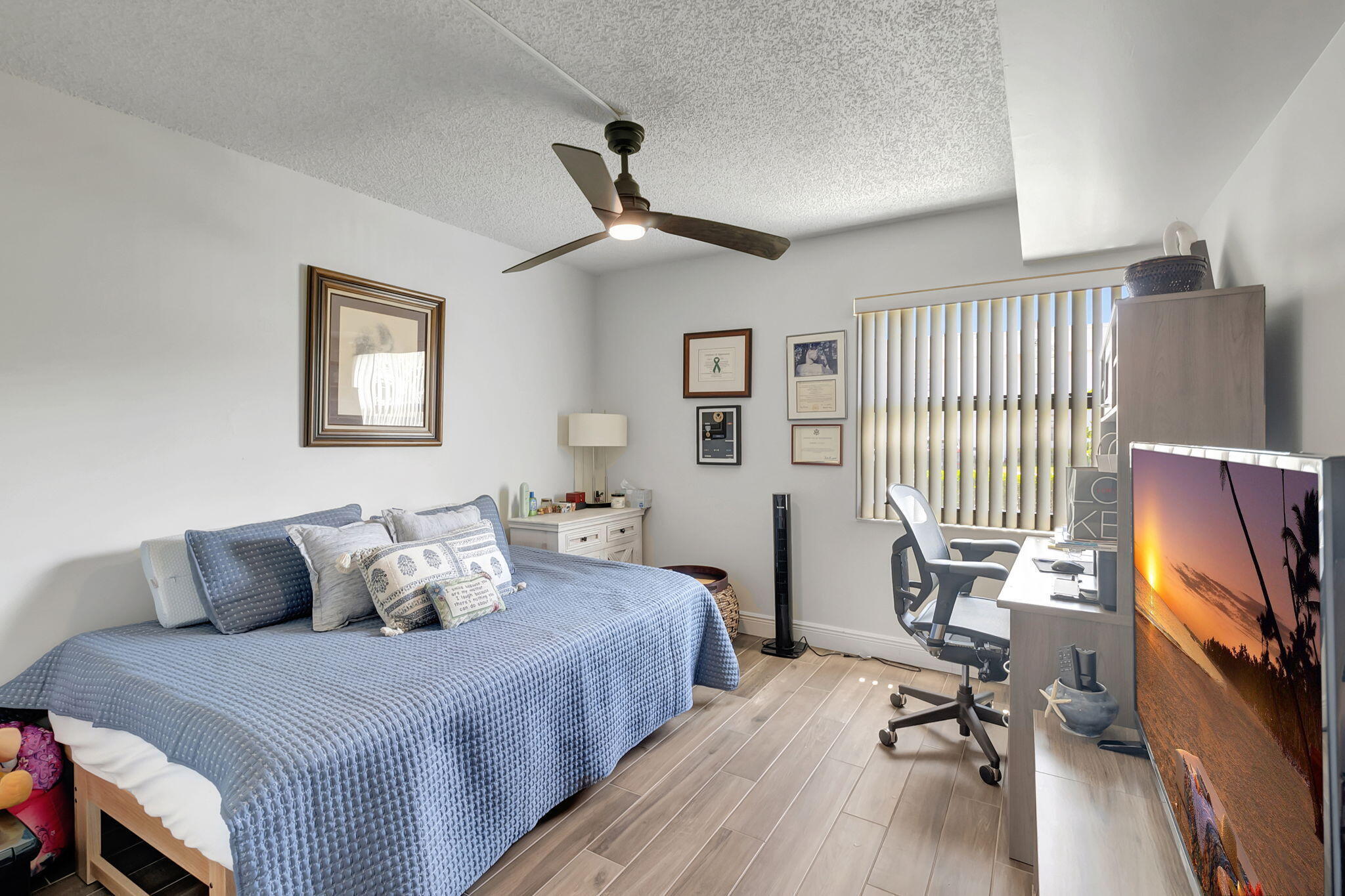 66 Capri B Delray Beach, FL 33484 - Photo 18 of 62 a bedroom with furniture and a flat screen tv