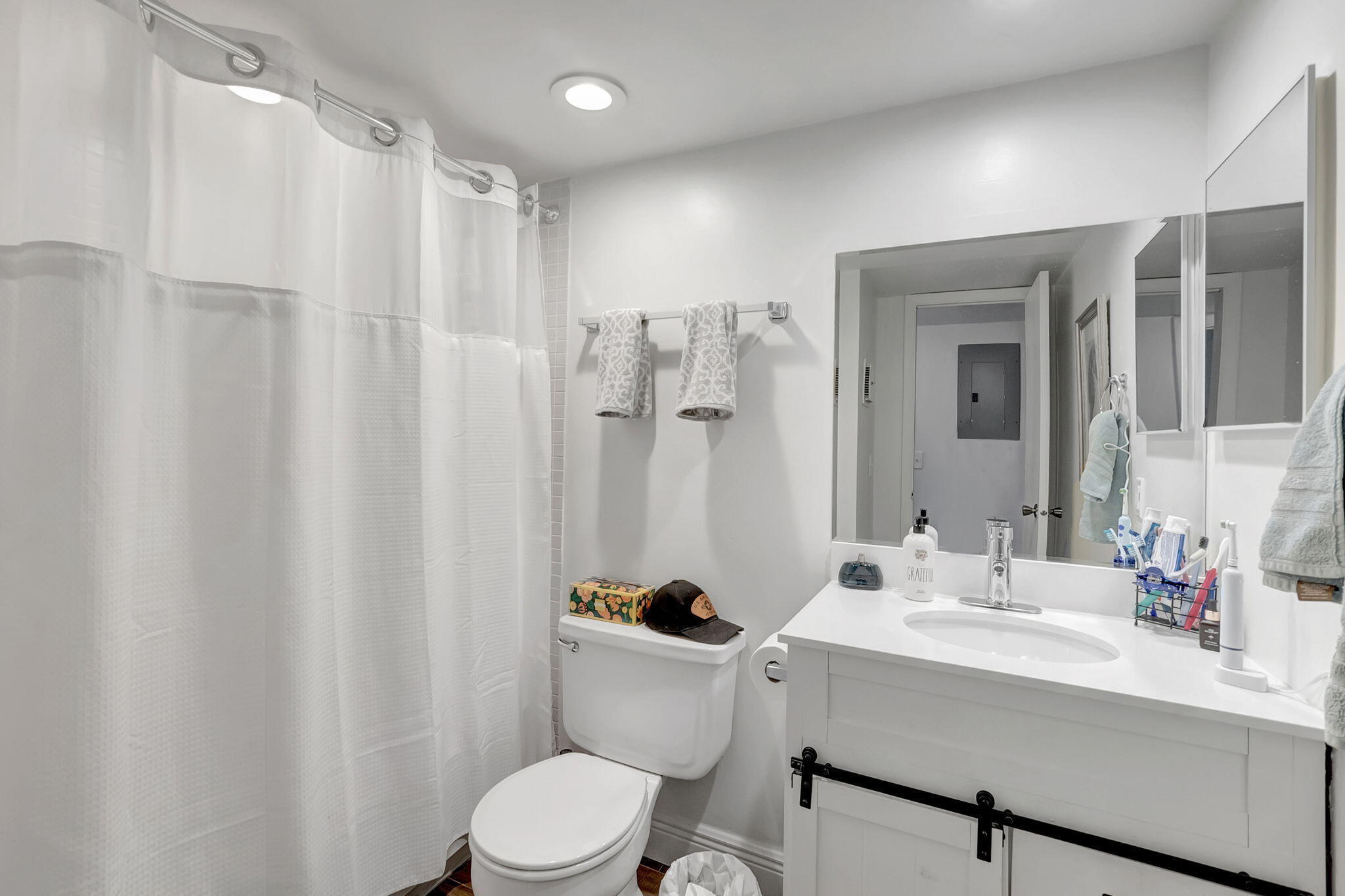 66 Capri B Delray Beach, FL 33484 - Photo 22 of 62 a bathroom with a sink a toilet and shower