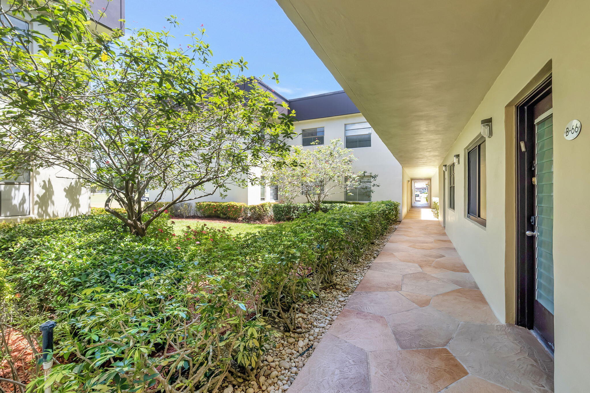 66 Capri B Delray Beach, FL 33484 - Photo 24 of 62 a view of a pathway both side of house