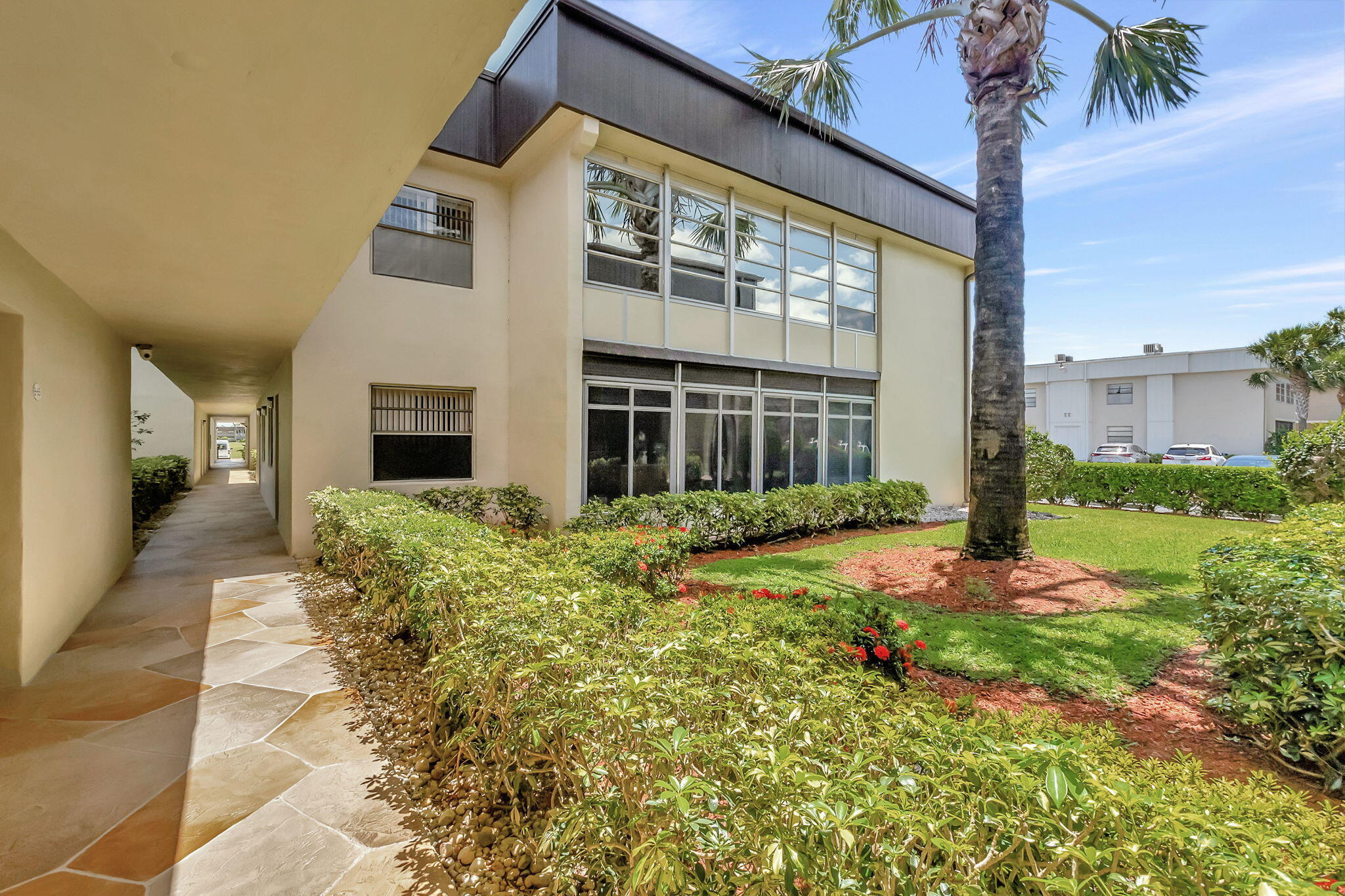 66 Capri B Delray Beach, FL 33484 - Photo 25 of 62 a front view of a house with garden