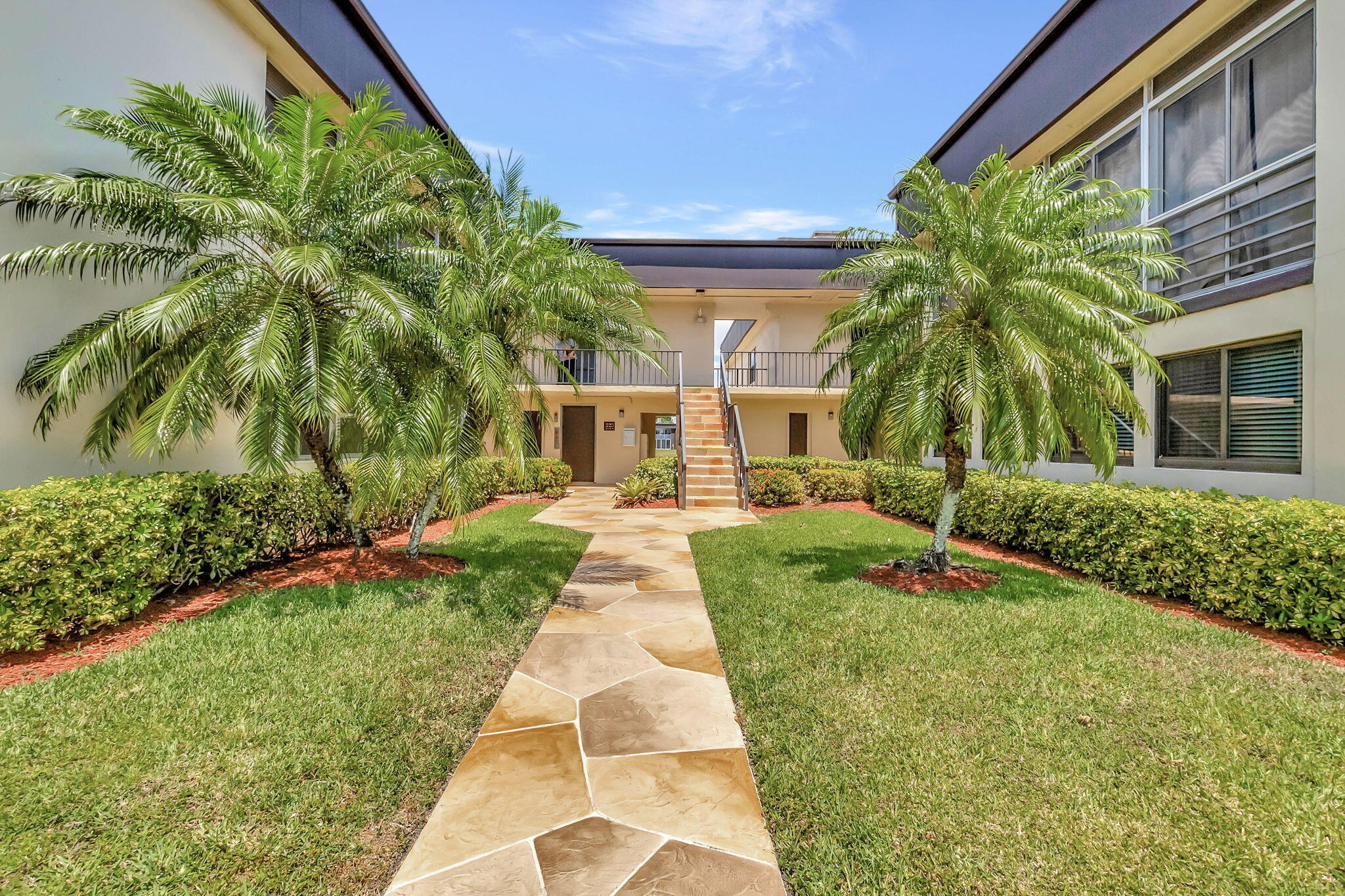 66 Capri B Delray Beach, FL 33484 - Photo 27 of 62 a front view of house with yard and green space