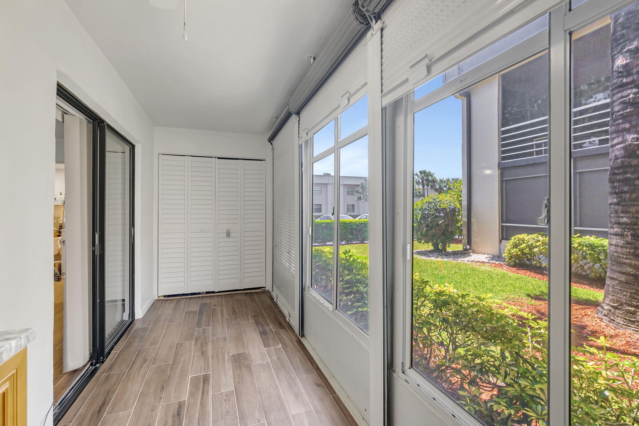 66 Capri B Delray Beach, FL 33484 - Photo 4 of 62 a view of hallway with a large window and wooden floor