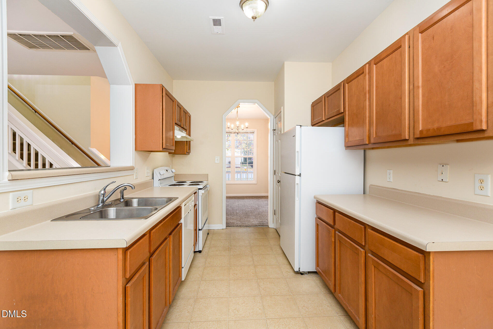 2124 Star Sapphire Drive Raleigh, NC 27610 - Photo 11 of 23 a kitchen with granite countertop a sink stove and refrigerator