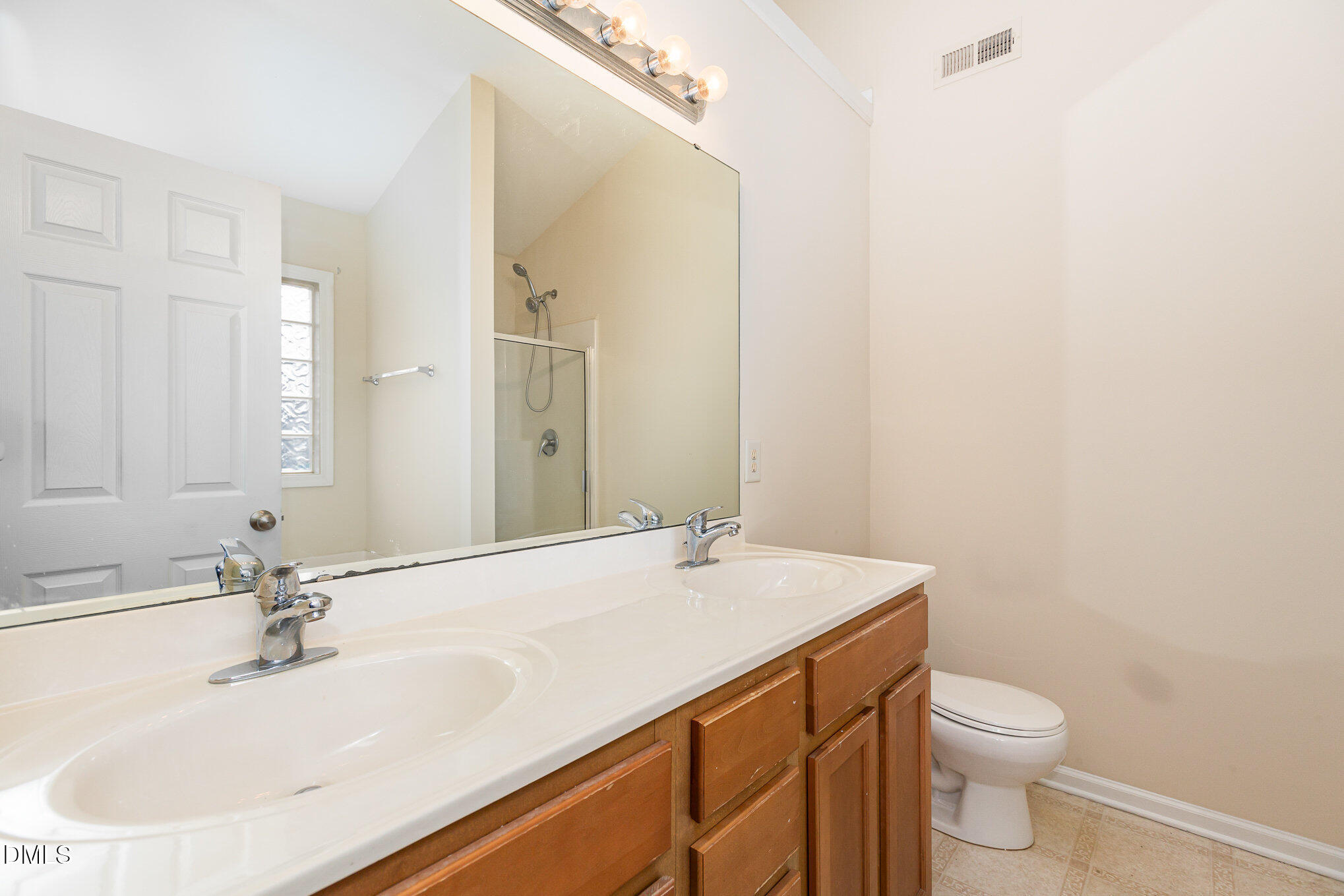 2124 Star Sapphire Drive Raleigh, NC 27610 - Photo 16 of 23 a bathroom with a sink a toilet and mirror