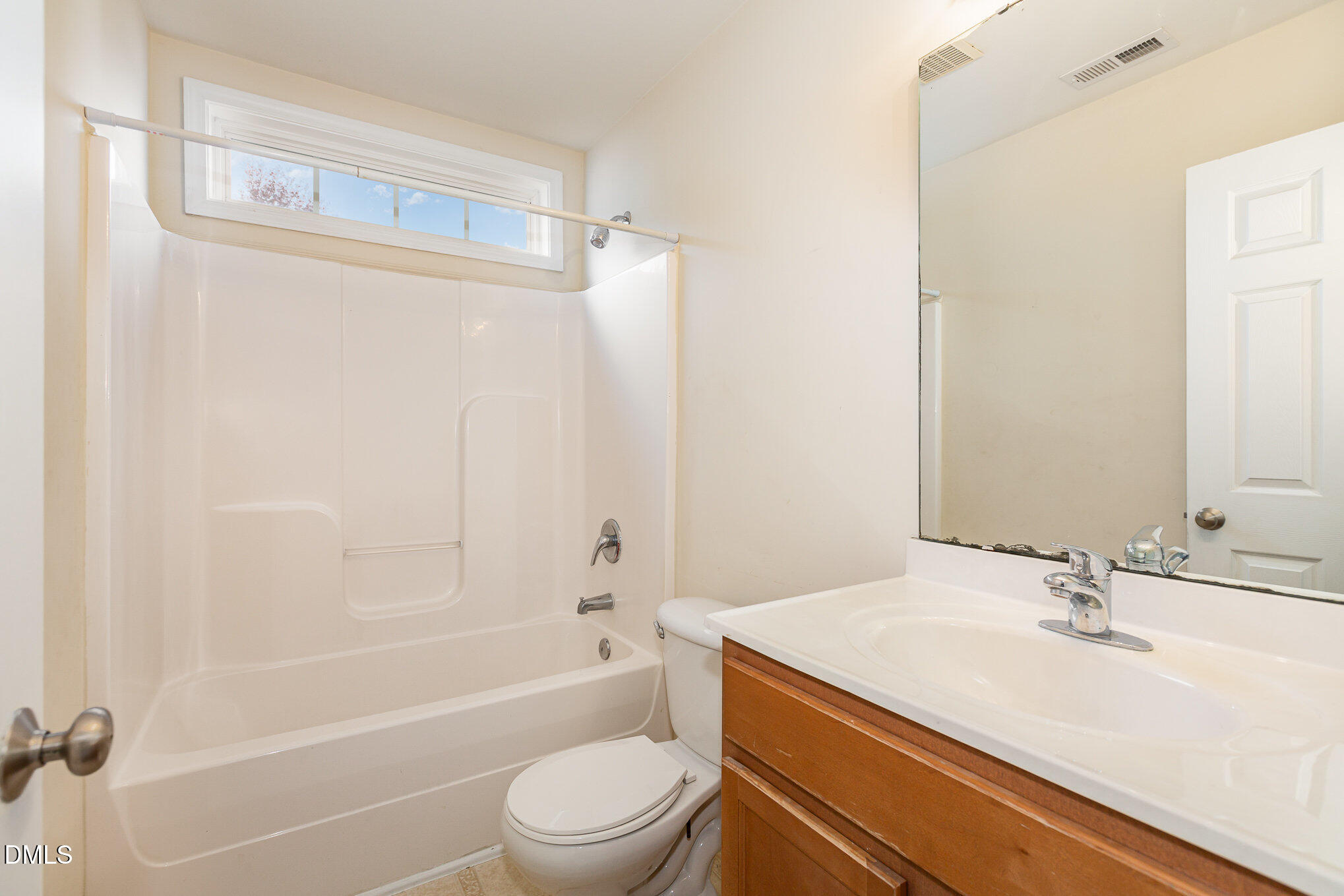 2124 Star Sapphire Drive Raleigh, NC 27610 - Photo 20 of 23 a bathroom with a sink a toilet and shower