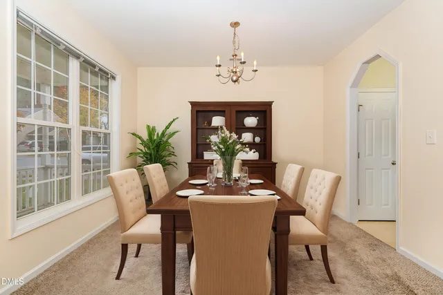 a view of a dining room with furniture and chandelier