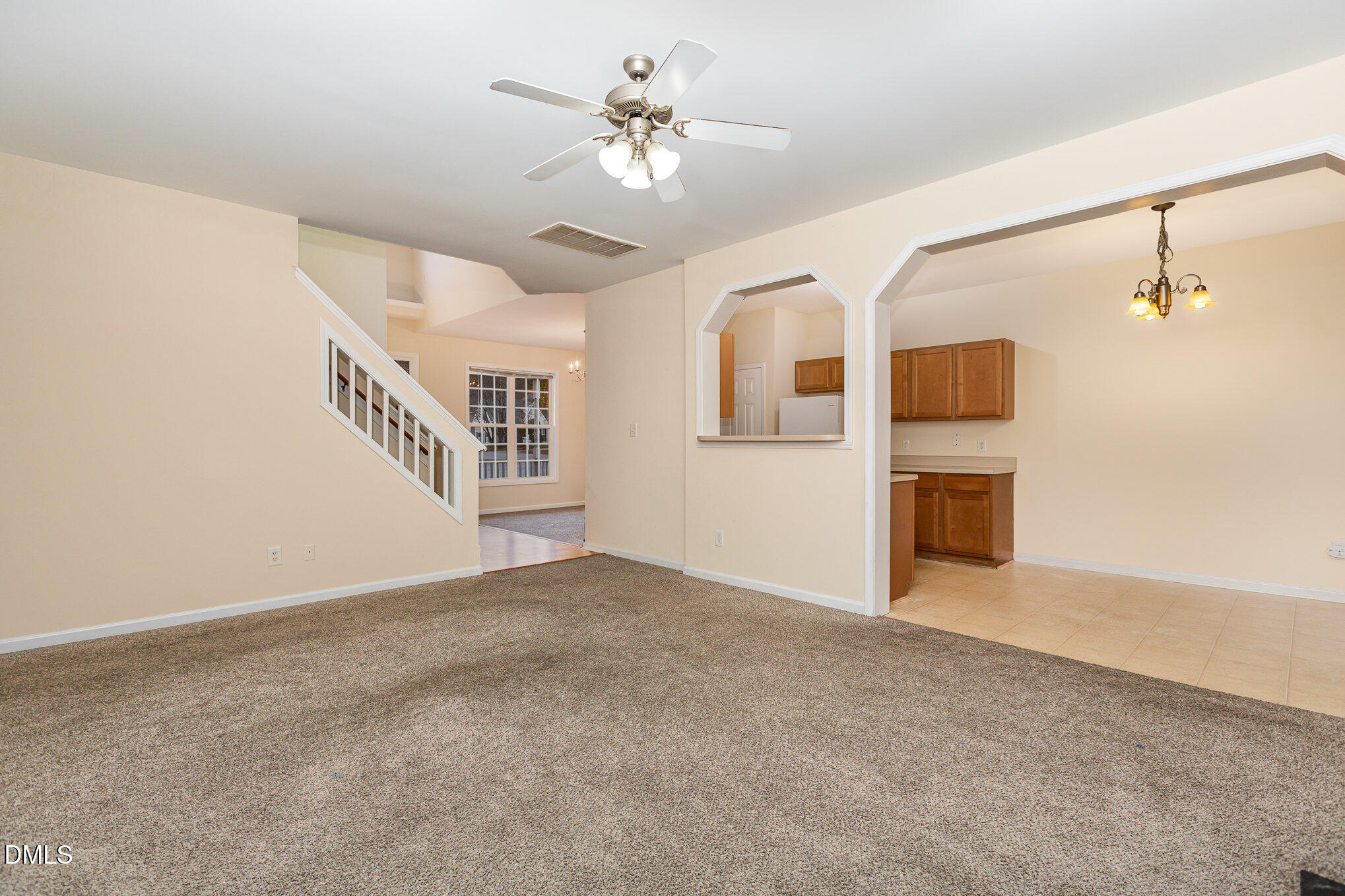 2124 Star Sapphire Drive Raleigh, NC 27610 - Photo 7 of 23 a view of a livingroom with a ceiling fan a ceiling fan and windows