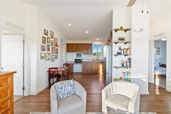 a living room with furniture and a kitchen view