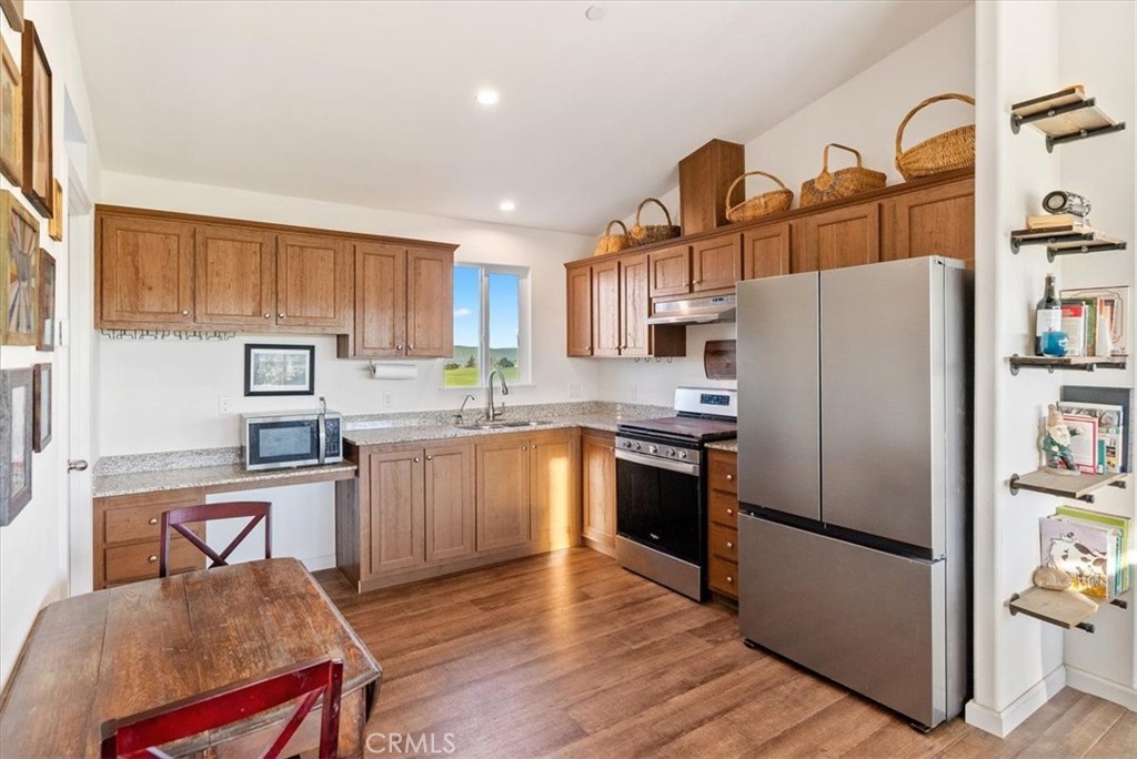 1730 Sutliff Road San Miguel, CA 93451 - Photo 12 of 57 a kitchen with granite countertop a refrigerator stove top oven and sink