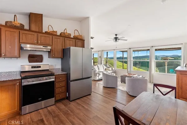 a kitchen with a refrigerator and a stove top oven