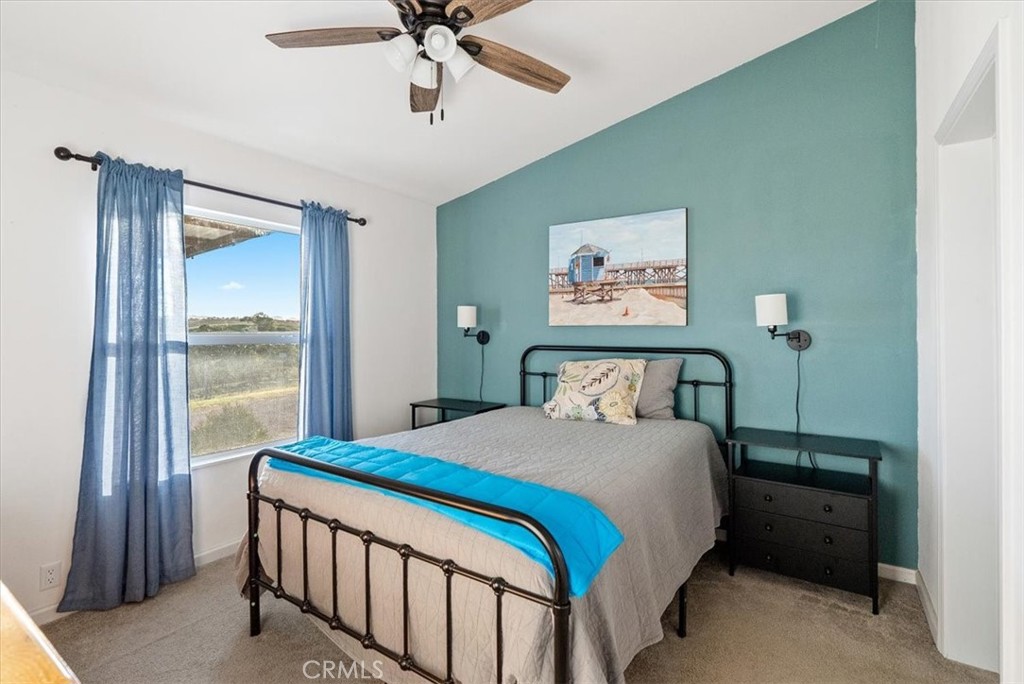 1730 Sutliff Road San Miguel, CA 93451 - Photo 17 of 57 a bedroom with a large bed and a chandelier