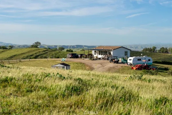 a view of car parked in middle of a field