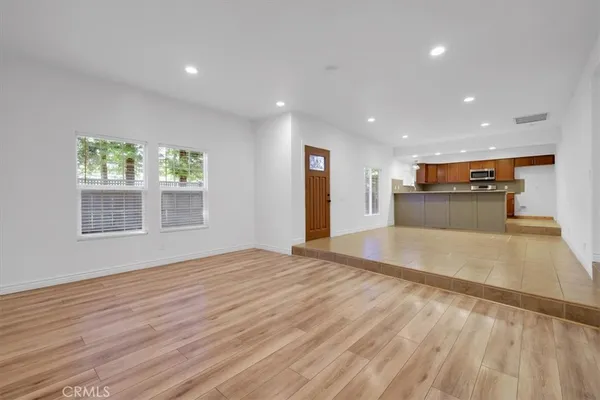 a kitchen with stainless steel appliances granite countertop a refrigerator and a stove top oven