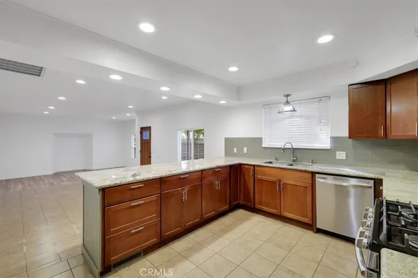 a kitchen with granite countertop cabinets stainless steel appliances and a sink