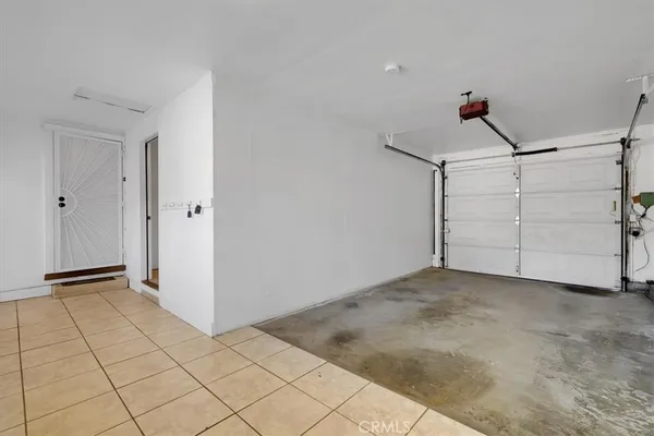 an empty room with wooden floor and cabinet