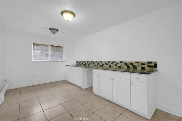 a bathroom with a granite countertop sink a large mirror and a