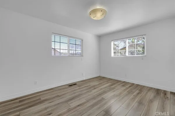 a view of house with backyard and trees
