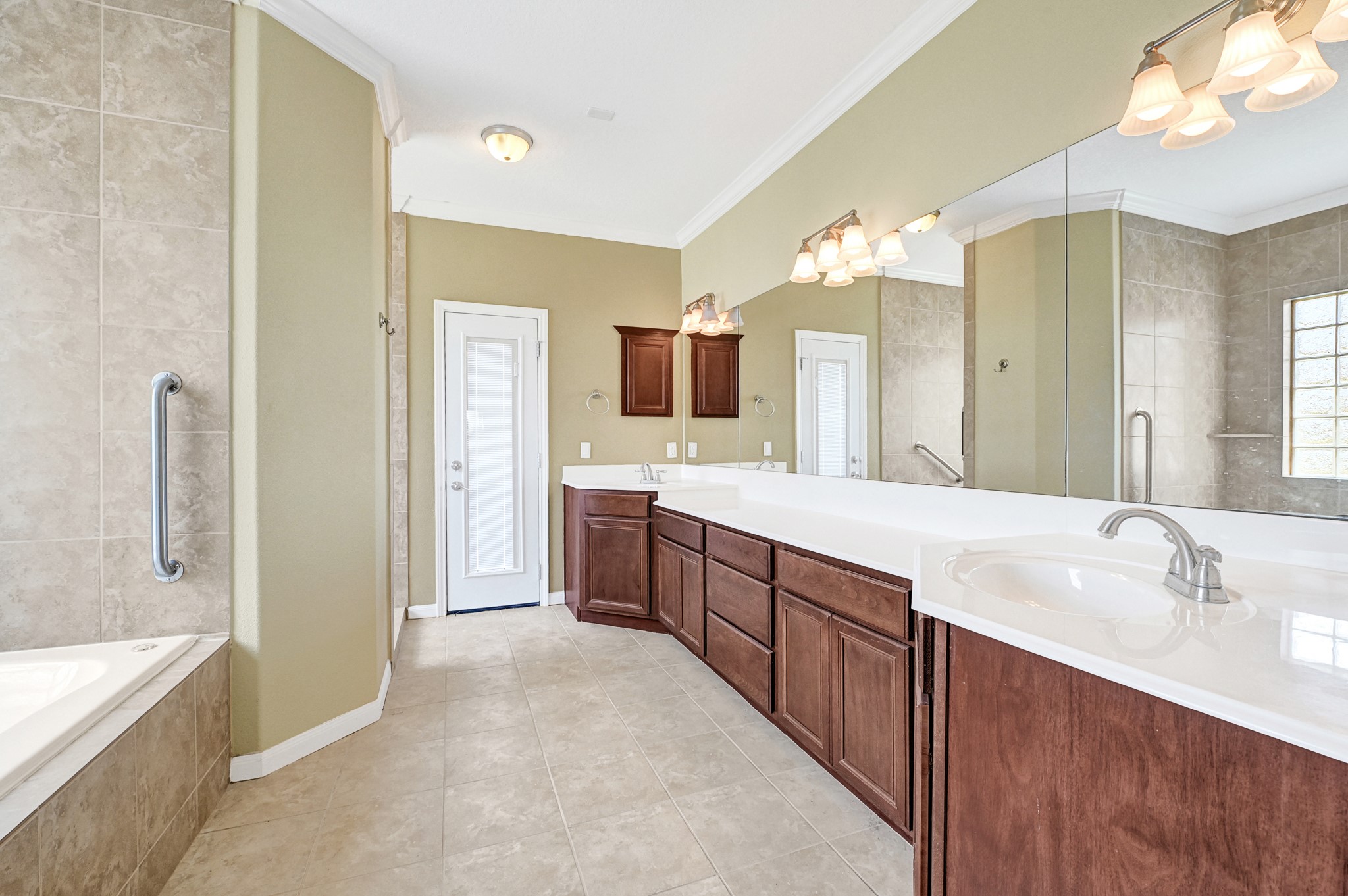 1004 8th Street Dickinson, TX 77539 - Photo 17 of 42 a spacious bathroom with a granite countertop sink mirror and a bathtub
