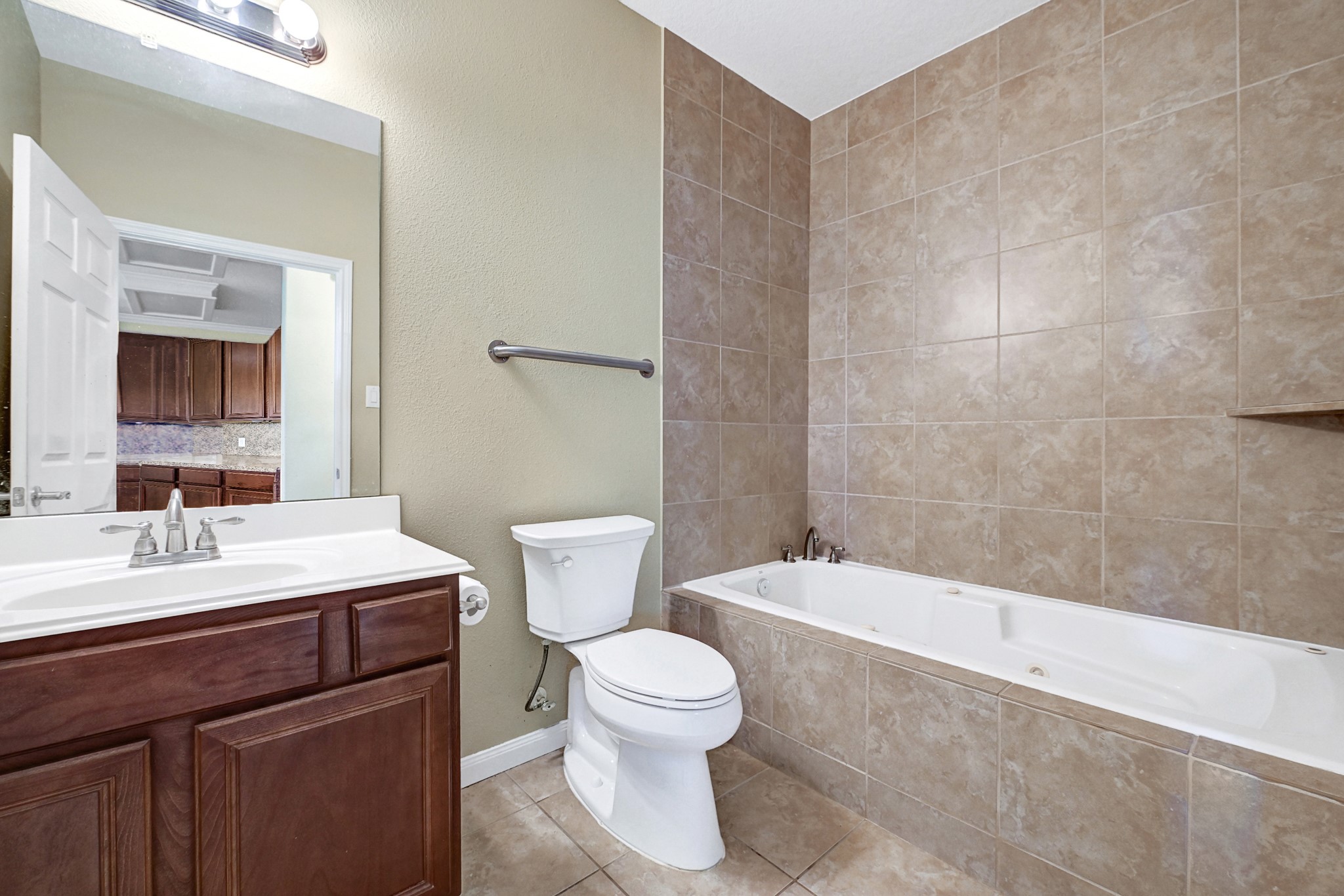 1004 8th Street Dickinson, TX 77539 - Photo 21 of 42 a bathroom with a sink a toilet and a mirror