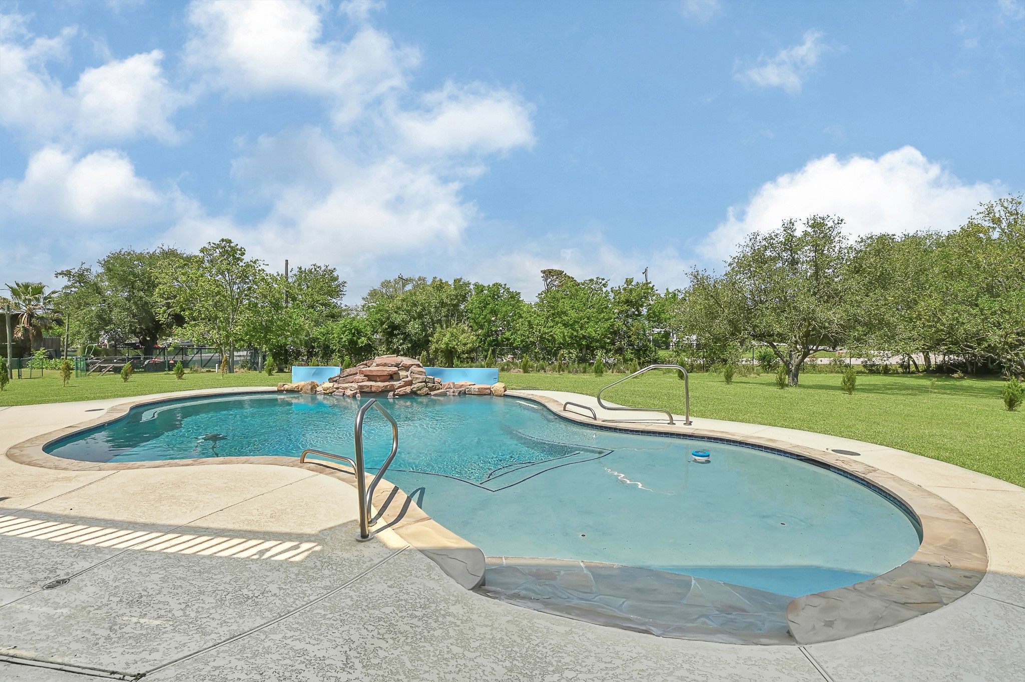 1004 8th Street Dickinson, TX 77539 - Photo 25 of 42 a view of a swimming pool with a yard