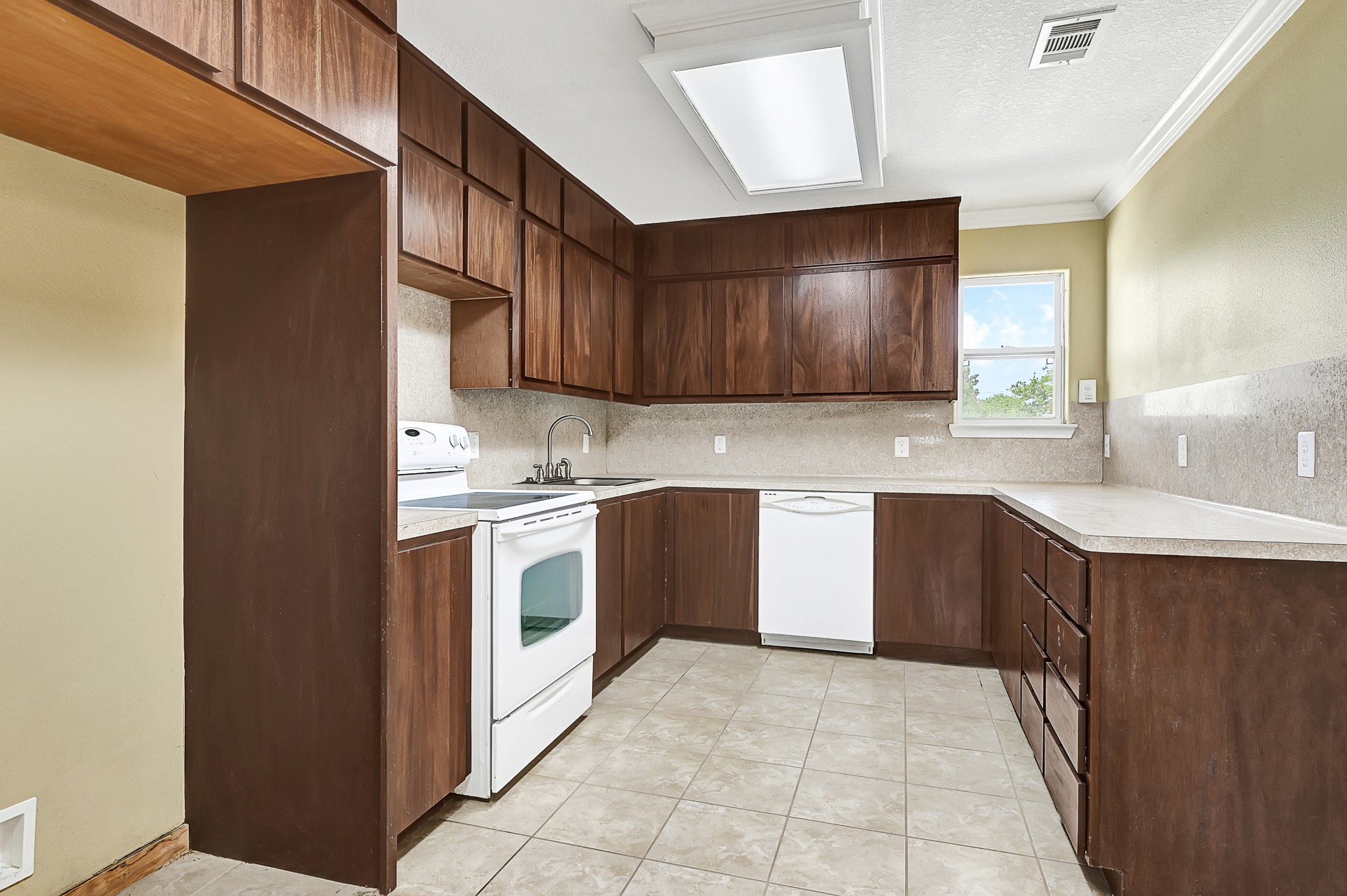1004 8th Street Dickinson, TX 77539 - Photo 29 of 42 a kitchen with a stove sink and cabinets