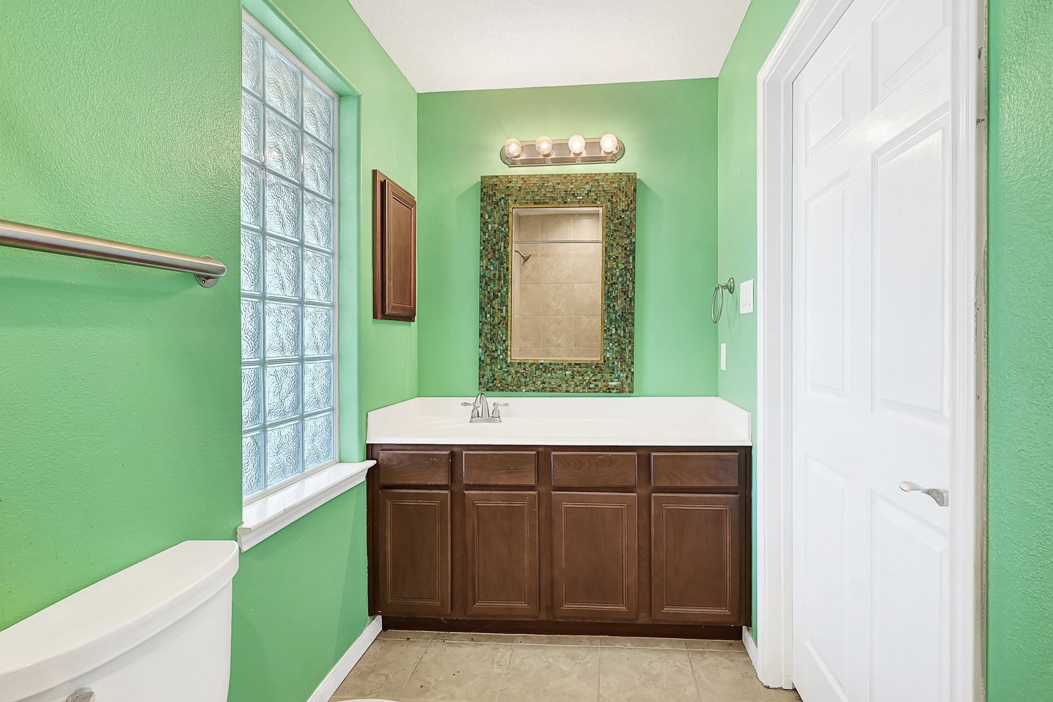 1004 8th Street Dickinson, TX 77539 - Photo 31 of 42 a bathroom with a sink and a mirror