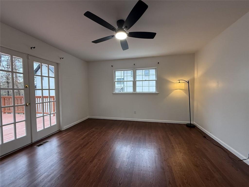 1438 Oak Forest Court Northeast Brookhaven, GA 30319 - Photo 14 of 15 a view of an empty room with wooden floor and a window