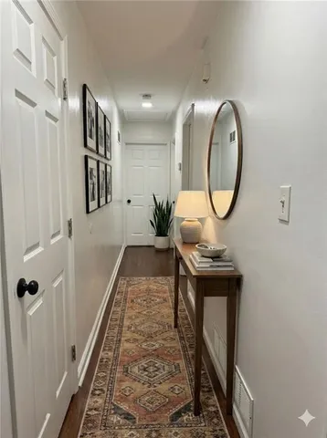 a view of a hallway with wooden floor