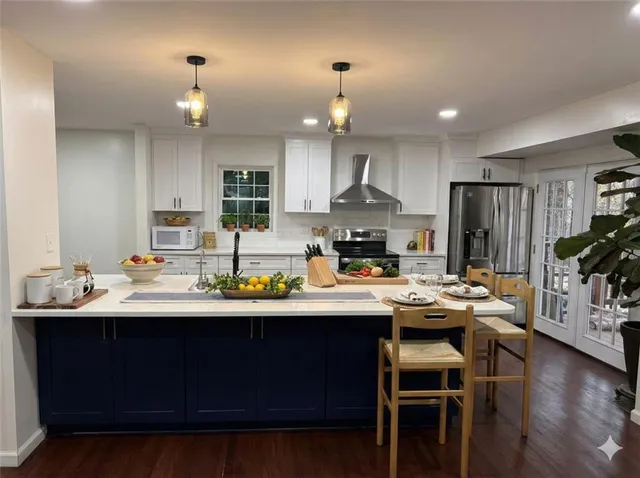 a kitchen with a sink stainless steel appliances and cabinets