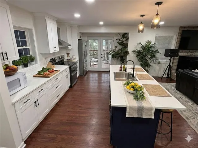 a large kitchen with a table and chairs in it