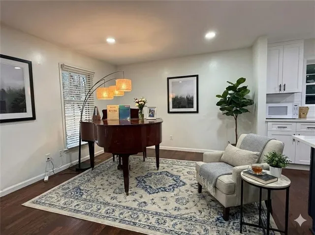 a living room with furniture and a wooden floor
