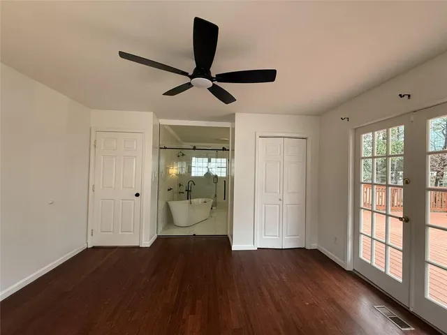 a view of a room with wooden floor cabinet and windows