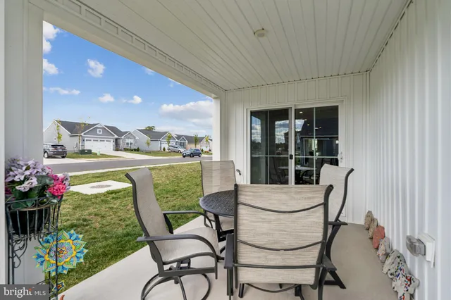 a view of a porch with furniture and garden