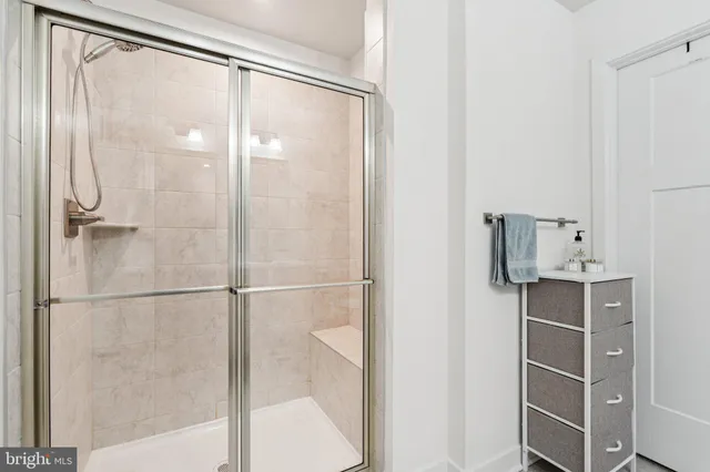 a bathroom with a glass shower door