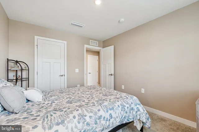 a bedroom with a bed and a mirror