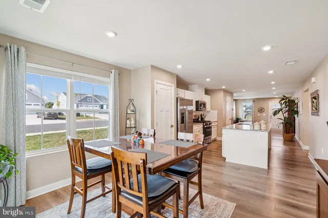 a dining room with furniture and wooden floor